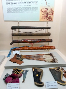 More quivers and arrows, arrow holders (front-left) and bow holders (front-right).